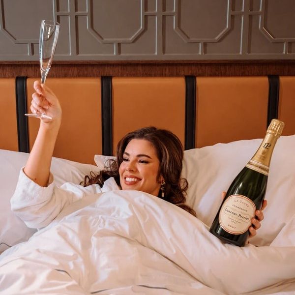 Woman Holding a Bottle of Bottle of Laurent-Perrier La Cuvée Champagne